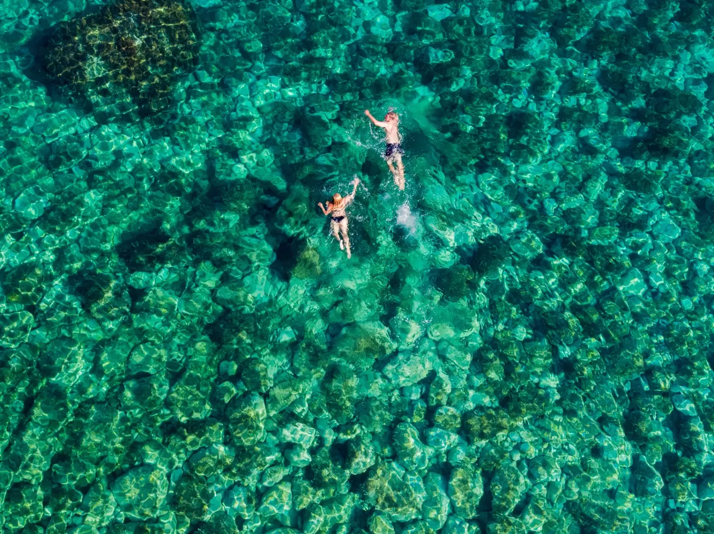 Swimmers off a sailboat in the Croatian Adriatic